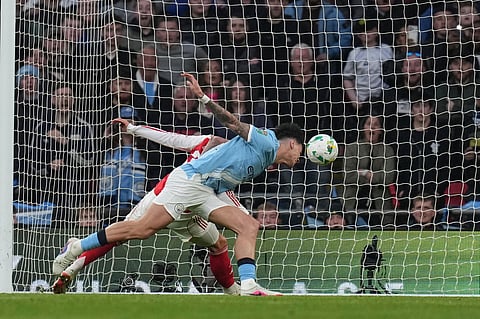 Manchester City's Nico O'Reilly, heads the ball and scores the opening goal during the English League Cup final soccer match between Arsenal and Manchester City in London, Sunday, March 22, 2026. 