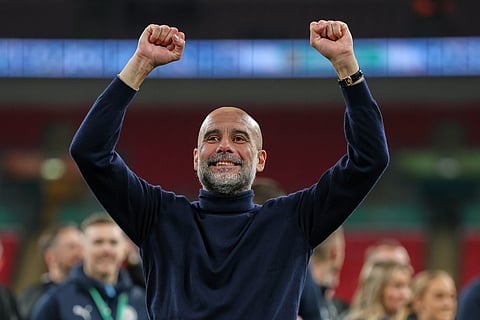Manchester City's head coach Pep Guardiola celebrates after his team won the English League Cup final soccer match between Arsenal and Manchester City in London, Sunday, March 22, 2026. 