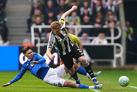 Sunderland's Chris Rigg, left, and Newcastle United's Lewis Hall battle for the ball during the Premier League match between Newcastle and Sunderland outside St James' Park, Newcastle upon Tyne, England.