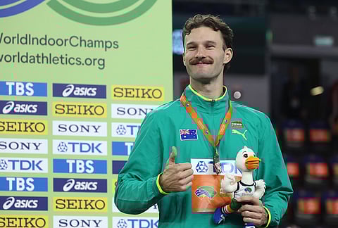 Kurtis Marschall, of Australia, poses on the podium after winning the bronze medal in the men's pole vault at the World Athletics Indoor Championships in Torun, Poland.