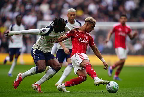 Nottingham Forest's Omari Hutchinson, right and Tottenham Hotspur's Mathys Tel vie for the ball, during the English Premier League soccer match between Tottenham Hotspur and Nottingham Forest, in London.
