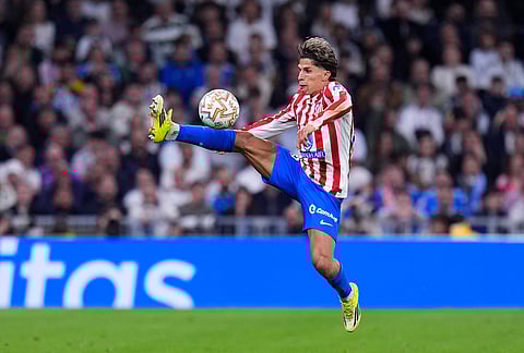 Atletico Madrid's Giuliano Simeone controls the ball during the Spanish La Liga soccer match between Real Madrid and Atletico Madrid in Madrid, Spain.