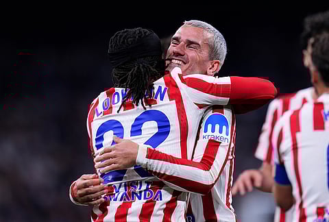 Atletico Madrid's Ademola Lookman, left, celebrates with Antoine Griezmann after scoring the opening goal during the Spanish La Liga soccer match between Real Madrid and Atletico Madrid in Madrid, Spain.