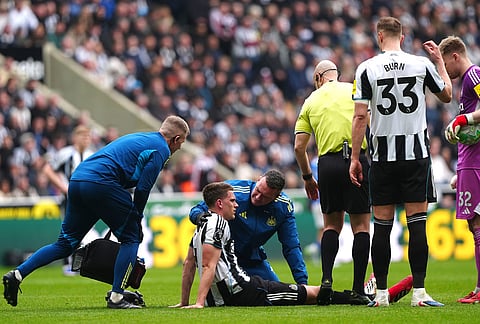 Newcastle United's Sven Botman receives treatment for a possible injury during the Premier League match between Newcastle and Sunderland outside St James' Park, Newcastle upon Tyne, England.