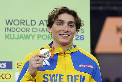 Armand Duplantis, of Sweden, poses on the podium after winning the gold medal in the men's pole vault.