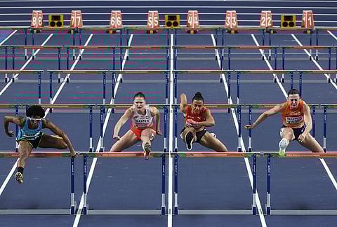 Devynne Charlton, of Bahamas, from left, Pia Skrzyszowska, of Poland, Ditaji Kambundji, of Switzerland, and Nadine Visser, of the Netherlands, compete in the women's 60 meters hurdles final at the World Athletics Indoor Championships in Torun, Poland.