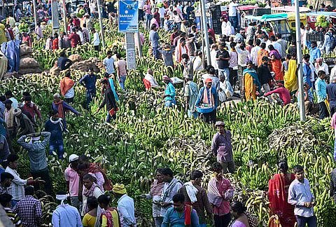 People shop for bananas amid preparations ahead of the ‘Chaiti Chhath’ festival, at Bazar samiti in Patna.