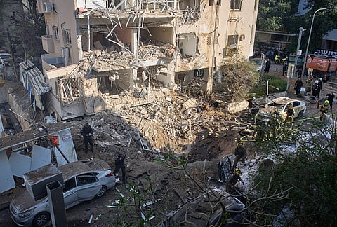 Israeli security forces and rescue team respond at the site of an Iranian missile strike in Tel Aviv, Israel.