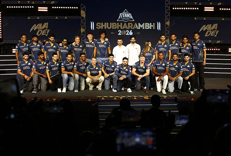 Gujarat Titans skipper Shubman Gill with team players, GT's directors Shaan Mehta and Jinal Mehta, former England player and GT’s director of cricket Vikram Solanki and others pose for a group photograph during the franchise's "Shubharambh 2026" event featuring the squad, owners and partners, in Ahmedabad. - | Photo: PTI