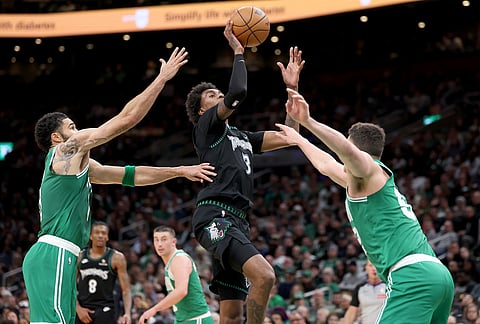 Boston Celtics forward Jayson Tatum (0) scores during the second half of an NBA basketball game against the Boston Celtics, in Boston.