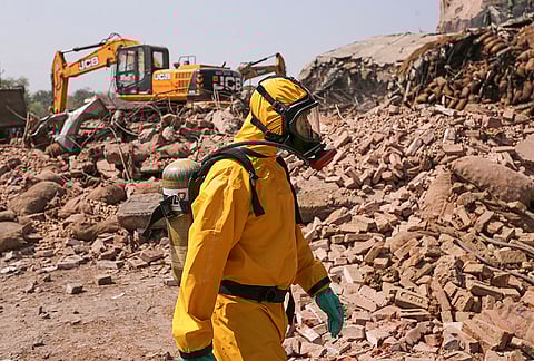 A National Disaster Response Force (NDRF) personnel in a hazmat suit after a portion of a cold storage collapsed on Monday, in Prayagraj. At least four labourers were killed and 14 were injured in the incident, the collapse also triggered an ammonia gas leak from the facility. 