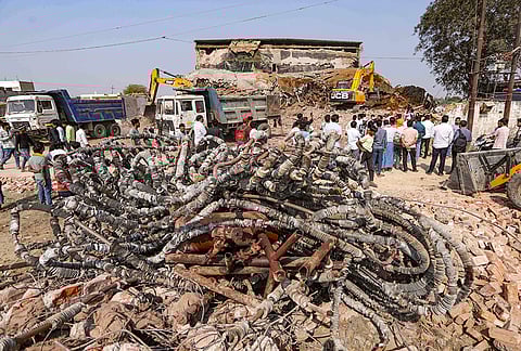 Municipal Corporation workers clear debris after a portion of a cold storage collapsed on Monday, in Prayagraj. At least four labourers were killed and 14 were injured in the incident, the collapse also triggered an ammonia gas leak from the facility. 