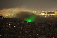 Day In Pics: March 24, 2026 | Photo: AP/Hassan Ammar : Smoke rises from the site of an Israeli airstrike in Dahiyeh, Beirut's southern suburbs.
