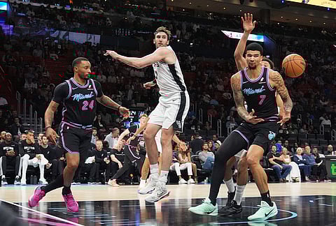 Miami Heat center Kel'el Ware (7) can't hold on to a pass from guard Norman Powell (24) during the second half of an NBA basketball game against the San Antonio Spurs, in Miami. 