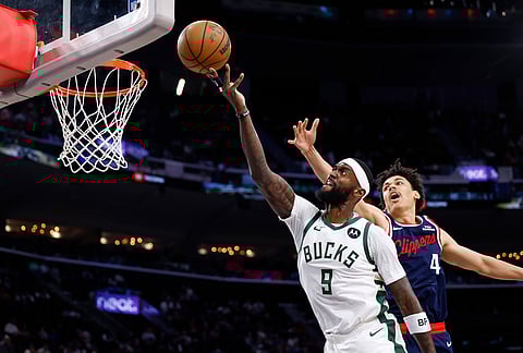 Milwaukee Bucks forward Bobby Portis (9) drives to the basket with the ball while being guarded by LA Clippers guard Kobe Sanders (4) during the first half of an NBA basketball game in Inglewood, California.