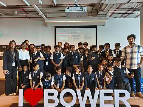 Students posing with "I ❤️ BOWER" sign