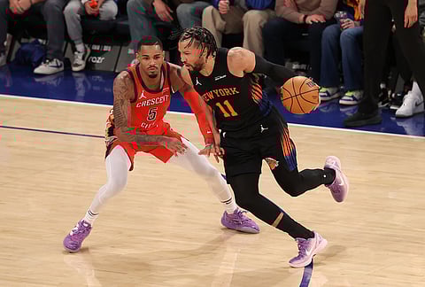 New York Knicks' Jalen Brunson (11) dribbles the ball against New Orleans Pelicans' Dejounte Murray (5) during the second half of an NBA basketball game in New York. 