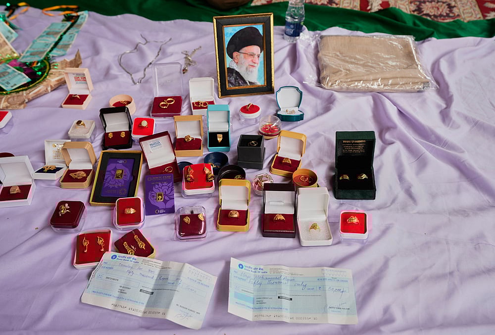 Personal jewelry and cheques are displayed among items collected during a relief drive for Iran in Budgam, Kashmir.