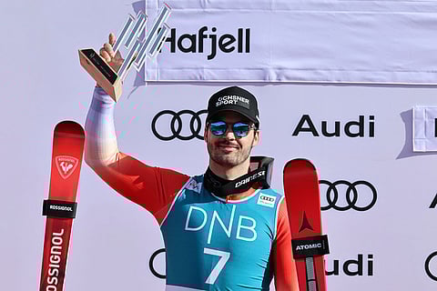 Switzerland's Loic Meillard celebrates on the podium after taking second place in an alpine ski, men's giant slalom race, at the Lillehammer World Cup Finals, in Hafjell, Norway.