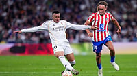 AP : Real Madrid's Kylian Mbappe, left, and Atletico Madrid's Marcos Llorente challenge for the ball during their La Liga match in Madrid, Spain.
