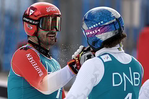 Brazil's Lucas Pinheiro Braathen is congratulated by Switzerland's Loic Meillard, left, after winning an alpine ski, men's giant slalom discipline title, at the Lillehammer World Cup Finals, in Hafjell, Norway.