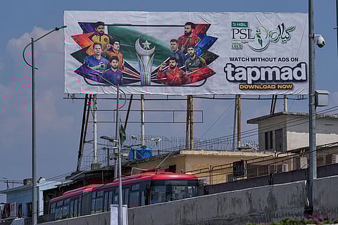 A metro bus moves a billboard of Pakistan's premier domestic T20 the Pakistan Super League, which will take place in empty stadiums due to the recent spike in oil prices, in Rawalpindi, Pakistan.
