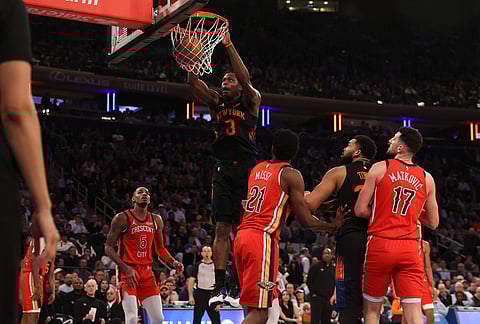 New York Knicks OG Anunoby (8) dunks the ball during the first half of an NBA basketball game against the New Orleans Pelicans, in New York.