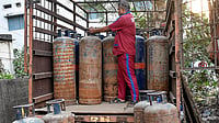 Representative Image : A worker arranges commercial LPG cylinders on a vehicle amid a shortage of cooking gas.