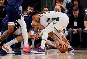 | Photo: AP/Caroline Brehman : LA Clippers center Brook Lopez (11) and Milwaukee Bucks guard Ryan Rollins (13) battle for possession for the ball during the second half of an NBA basketball game in Inglewood, California.