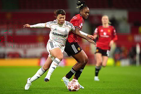 Bayern Munich's Momoko Tanikawa, left, and Manchester United's Melvine Malard battle for the ball during the Women's Champions League match between Manchester United and Bayern Munich in Manchester, England.
