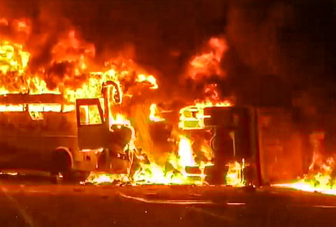 Flames billow from a private bus after it caught fire, in Rayavaram, Andhra Pradesh. At least 14 people were killed and 23 injured in the incident. 