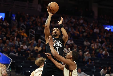 Brooklyn Nets guard Tyson Etienne (10) shoots against Golden State Warriors guard De'anthony Melton, right, during the first half of an NBA basketball game in San Francisco.