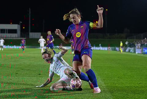 Barcelona's Alexia Putellas, right, and Real Madrid's Eva Navarro vie for the ball during the women's Champions League quarterfinal first leg soccer match between Real Madrid and Barcelona in Madrid, Spain.
