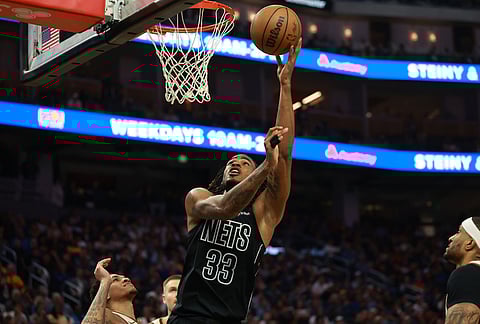 Brooklyn Nets center Nic Claxton (33) shoots against Golden State Warriors guard Will Richard, left, during the first half of an NBA basketball game in San Francisco.
