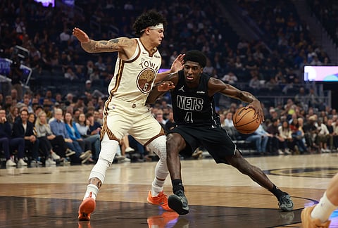 Brooklyn Nets guard Drake Powell (4) drives to the basket against Golden State Warriors forward Gui Santos (15) during the first half of an NBA basketball game in San Francisco.