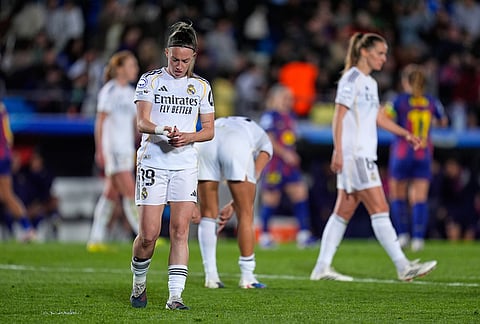 Real Madrid's Eva Navarro, left, reacts after the women's Champions League quarterfinal first leg soccer match between Real Madrid and Barcelona in Madrid, Spain.