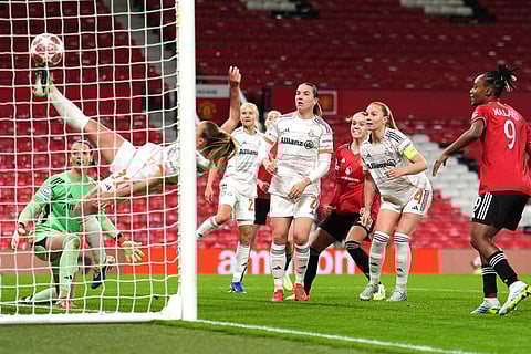 Manchester United's Hanna Lundkvist, center, scores their side's second goal of the game as Bayern Munich's Georgia Stanway attempts to clear during the Women's Champions League match between Manchester United and Bayern Munich in Manchester, England.