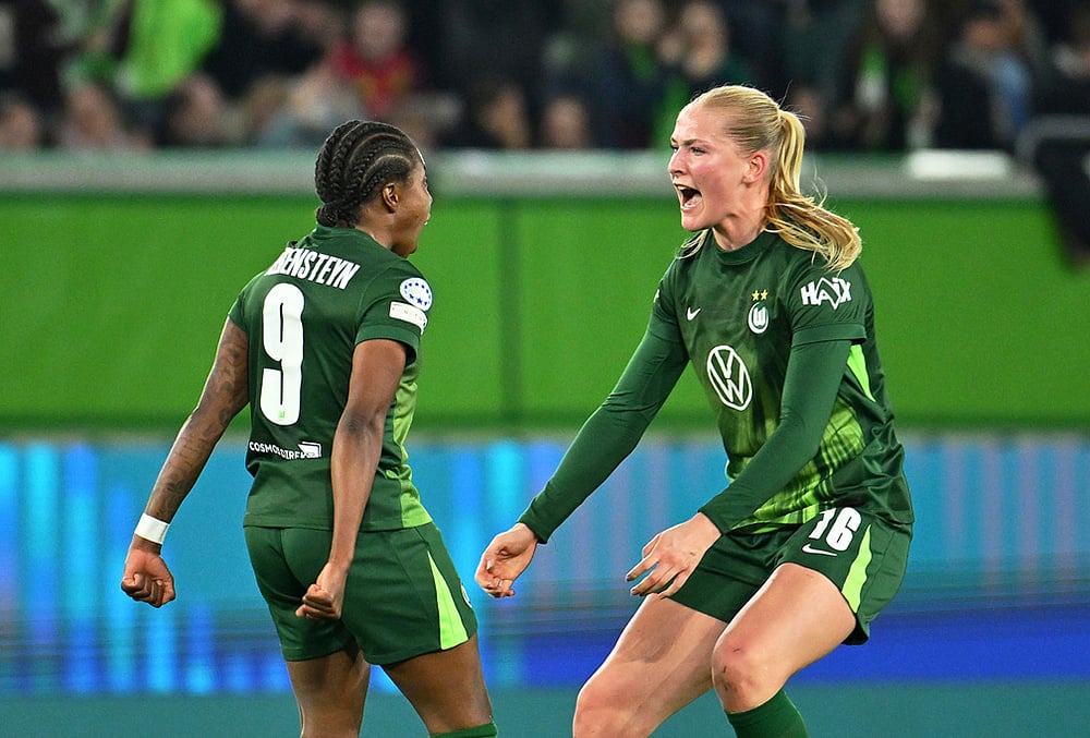 Wolfburg's Lineth Beerensteyn, left, celebrates after scoring with teammate Camilla Kuever during their Champions League quarter-finals, first leg soccer match in Wolfsburg, Germany. - | Photo: Swen Pfortner/dpa via AP