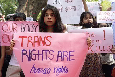 Supporters of the LGBTQIA+ community hold placards during a protest against the passage of the Transgender Persons (Protection of Rights) Amendment Bill, 2026, at Jantar Mantar in New Delhi.
