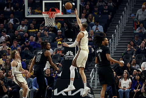 Golden State Warriors center Kristaps Porzingis (7) shoots against Brooklyn Nets center Nic Claxton (33) during the first half of an NBA basketball game in San Francisco.