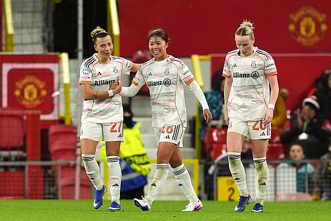 Bayern Munich's Momoko Tanikawa, center, celebrates scoring their side's third goal of the game during the Women's Champions League match between Manchester United and Bayern Munich in Manchester, England.