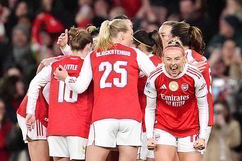 Arsenal's Chloe Kelly, right, celebrates scoring their side's second goal of the game with team-mates during the Women's Champions League soccer match between Arsenal and Chelsea in London.