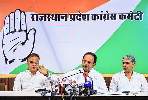 Congress leader Raghu Sharma, centre, addresses a press conference, in Jaipur.
