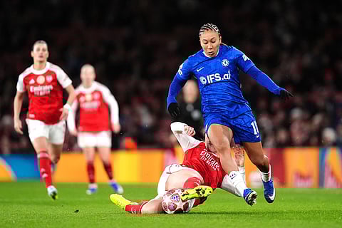 Arsenal's Lotte Wubben-Moy, bottom left, and Chelsea's Lauren James battle for the ball during the Women's Champions League soccer match between Arsenal and Chelsea in London.