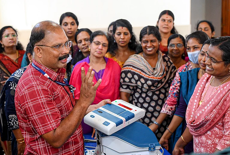 A polling official demonstrates the operation of EVM and VVPAT units during a training programme ahead of the Kerala Legislative Assembly Elections, in Thiruvananthapuram, Kerala. - | Photo: PTI