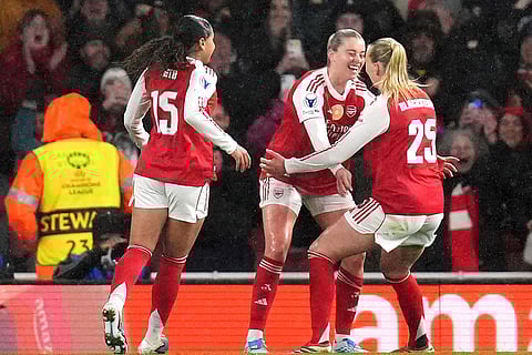 Arsenal's Alessia Russo, center celebrates scoring their side's third goal of the game with teammates Olivia Smith, left, and Stina Blackstenius during the Women's Champions League soccer match between Arsenal and Chelsea in London.