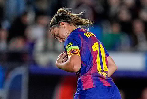Barcelona's Alexia Putellas celebrates after scoring her side's sixth goal from the penalty spot during the women's Champions League quarterfinal first leg soccer match between Real Madrid and Barcelona in Madrid, Spain.