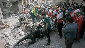 AP Photo/ Mati Hashemi : First responders inspect a destroyed car at the site of a residential building hit in an overnight strike during the U.S.-Israeli military campaign in Tabriz, East Azerbaijan Province, northwestern Iran, Tuesday, March 24, 2026