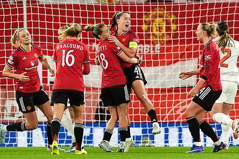 Manchester United's Maya Le Tissier, center, celebrates scoring their side's first goal of the game from the penalty spot during the Women's Champions League match between Manchester United and Bayern Munich in Manchester, England.