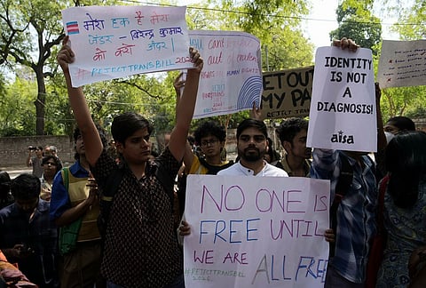 Supporters of the LGBTQIA+ community hold placards during a protest against the passage of the Transgender Persons (Protection of Rights) Amendment Bill, 2026, at Jantar Mantar in New Delhi.